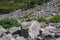 Pile of rocks, stones markers for orientation in area. Travel through mountain valley