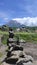 pile of rocks with a volcano in the background