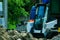 A pile of rubble and soil in the foreground. in the background a mini bulldozer loader