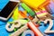 A pile of school supplies on a blue wooden table background. The concept of the educational process, doing homework.