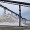 Pile of sea salt under conveyor of saline refinery