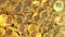 A pile of shiny golden bitcoin tokens or coins, top down view. Cryptocurrency related conceptual 3D rendering