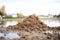 pile of silty soil near a river or lake showing its smooth texture