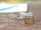 Pile of silvers Thai coins on the wooden table with blurred pencil