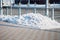 A pile of snow on the street in winter after cleaning the sidewalk.