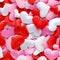 Pile of soft red, pink, and white cloth hearts for romantic or Valentine`s Day background