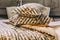 Pile of soft zebra design pillows on bed with natural plant ornaments. Pillows product photoshoot in bedroom