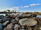 Pile of solid rocks with the water and sky