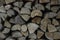 Pile of stacked firewood in rural garden ready for winter. Preparation for the winter. Wooden log abstract background