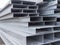 Pile steel channel for construction of a house to an outdoor site. Steel beams for the roof. Profile pipes