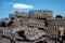 A pile of steel tracks combat Soviet tanks against the blue sky.