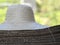 A pile of straw hats with wide brims and beautiful design