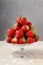 Pile of strawberries on glass cake stand