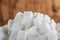 Pile of Sugar Cubes over Wooden Background.