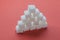 Pile of Sugar Cubes Stacking on red background.
