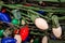 Pile of tangled large bulb Christmas lights with green wire