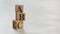 Pile with three wooden cubes - letters ABC on them, space for more text / images on right side