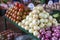 pile of tomatoes and red and white onion in the market