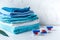 Pile of towels with detergent on laundry background mockup