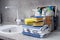 Pile of towels, sponges and various cleaning products on the kitchen table next to the sink