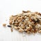 Pile of uncooked multigrain rice on white wooden background