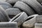 The pile of used automobile tires in the junkyard