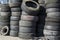 A pile of used car tires stacked in a rubber tower