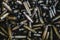 Pile of used rifle cartridges 7.62 mm caliber, many empty bullet shells, assault rifle bullet shell, military background, top view