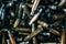 Pile of used rifle cartridges 7.62 mm caliber, many empty bullet shells, assault rifle bullet shell, military background, top view