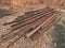 Pile of used rusty rails. Stock of steel rails at old closed railway station. Metal material