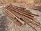 Pile of used rusty rails. Stock of steel rails at old closed railway station. Metal material