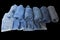 A pile of variety jeans were folded together show bottom of leg part lay  omn black background