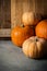 Pile of Various Kinds of Pumpkins Different Colors Orange Pale Peach on Stone Background Barn Weathered Wood.