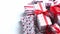 A pile various size wrapped in festive paper boxed gifts placed on stack. Christmas concept