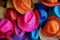 pile of vibrant beach hats ready for a shop window
