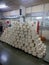 A pile of white cotton yarn bobbin put on table in textile spinning plant