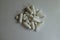 Pile of white magnesium citrate capsules and vitamin K2 tablets from above