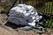 Pile of white sand bags on black nylon cover prepared for flood protection in case of emergency