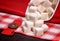 Pile of white sugar cubes on a linen tablecloths