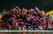 Pile of wild dried cranberries in a glass jar with dark background