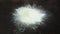 Pile of Xanthan Gum Powder on dark surface. Food additive E415. Used in culinary