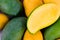 A pile yellow ripe mango and fresh green mango and half mango on white background healthy fruit food