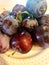 Piled purple plum fruits on a white platter