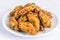 Piled Up Fried Chicken Wings on a White Plate