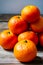 Piled up orange fruits on a wooden surface generated by ai