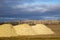 Piles of agricultural lime crushed limestone ready to be spread on the field to neutralize soil acidity and promote healthy plan