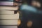 Piles of books on table over blurred library