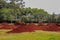 Piles of bright, saturated and oily red soil on a field with a tractor in Nairobi