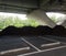 Piles of brown mulch under a bridge