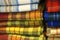 Piles of colorful woven wool tartan plaid cloth fabric